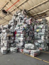 a large pile of clothes in a warehouse